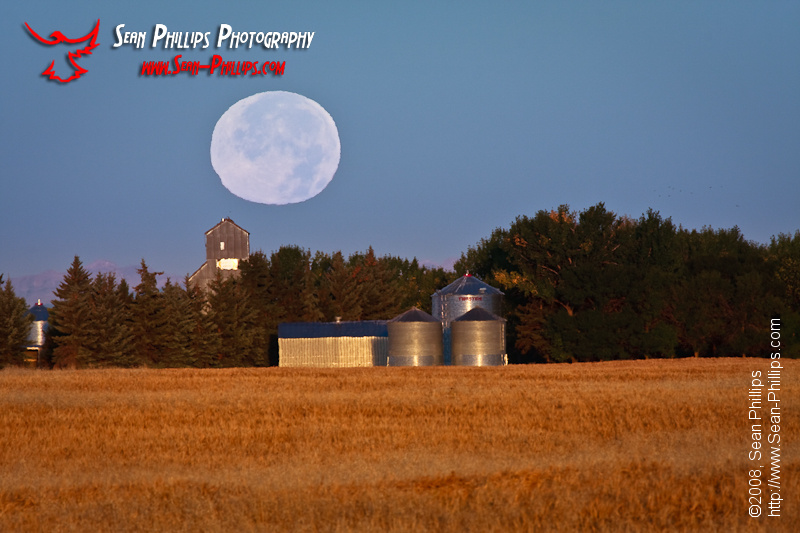 The Harvest Moon setting over a Granary